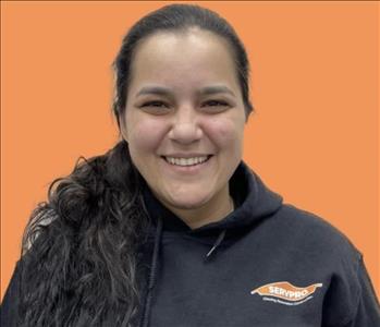 woman in front of orange wall