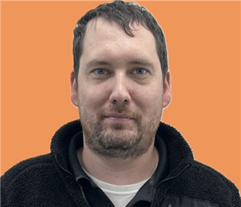 man in front of orange background