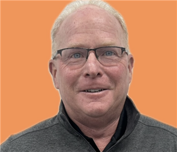 man in front of orange background