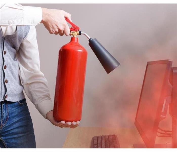 Man using fire extinguisher to stop fire